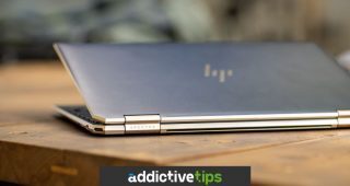 Blur HP Spectre laptop on a brown table